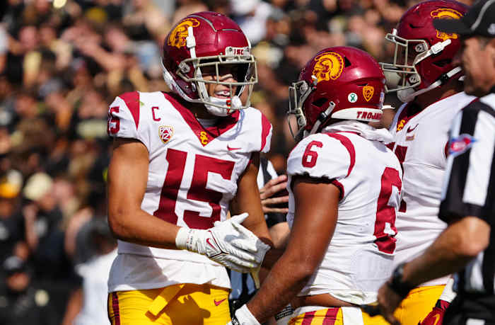 Oct 2, 2021; Boulder, Colorado, USA; USC Trojans wide receiver Drake London (15) and running back Vavae Malepeai (6) celebrate a score in the second half against the Colorado Buffaloes at Folsom Field. Mandatory Credit: Ron Chenoy-USA TODAY Sports